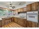 Kitchen featuring wood cabinetry, wood-look flooring, and modern appliances at 1810 Roanoke Ave, Lakeland, FL 33803