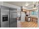 Kitchen with stainless steel refrigerator, wood cabinets, and wood-look flooring at 1810 Roanoke Ave, Lakeland, FL 33803