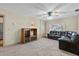 Living room showcasing a dark leather sofa, carpeted floor, and a display cabinet at 1810 Roanoke Ave, Lakeland, FL 33803