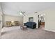 Bright living room featuring plush carpet and a ceiling fan at 1810 Roanoke Ave, Lakeland, FL 33803