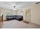 Comfortable living room with neutral carpet, dark leather sofa, and a view of the exterior at 1810 Roanoke Ave, Lakeland, FL 33803