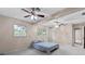 Bright main bedroom features two ceiling fans, neutral carpet and plenty of space at 1810 Roanoke Ave, Lakeland, FL 33803
