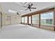 Bright sunroom features many windows, ceiling fans and carpet flooring at 1810 Roanoke Ave, Lakeland, FL 33803