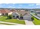 Aerial view of a well-maintained single-story home with manicured lawn and landscaping in a residential community at 204 Walkers Point Dr, Auburndale, FL 33823