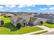 An aerial perspective of a landscaped single-story home in a well-planned neighborhood near a scenic lake at 204 Walkers Point Dr, Auburndale, FL 33823