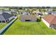 Aerial view of the home featuring a screened lanai, and a well-maintained lawn at 204 Walkers Point Dr, Auburndale, FL 33823