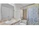 Bright bathroom featuring a shower-tub combo with decorative curtain and single sink vanity at 204 Walkers Point Dr, Auburndale, FL 33823