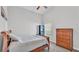 Neutral bedroom features a vaulted ceiling, built-in shelves, and a warm toned dresser at 204 Walkers Point Dr, Auburndale, FL 33823