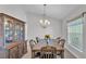 Traditional dining room with wood table, chairs, china cabinet and chandelier lighting at 204 Walkers Point Dr, Auburndale, FL 33823