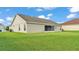 Side view of the home featuring a stucco exterior, screened lanai, and well-kept lawn at 204 Walkers Point Dr, Auburndale, FL 33823