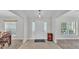 Bright foyer with tiled flooring, decorative rug and natural light streaming in from the sidelight windows at 204 Walkers Point Dr, Auburndale, FL 33823