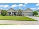 Charming single-story home with a well-manicured lawn, cozy front porch, and attached two-car garage at 204 Walkers Point Dr, Auburndale, FL 33823