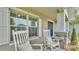 Inviting front porch with rocking chairs, stone accents, and decorative shutters offering a cozy outdoor space at 204 Walkers Point Dr, Auburndale, FL 33823