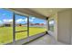 View from the screened lanai, overlooking the well-maintained lawn and neighboring houses at 204 Walkers Point Dr, Auburndale, FL 33823