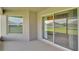 Covered lanai with sliding glass doors and view of the lawn at 204 Walkers Point Dr, Auburndale, FL 33823