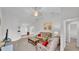 Open-concept living room featuring vaulted ceilings, neutral-toned carpet, comfortable seating, and access to other rooms at 204 Walkers Point Dr, Auburndale, FL 33823