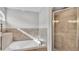 Soaking tub and glass shower are the highlights of this bright main bathroom at 204 Walkers Point Dr, Auburndale, FL 33823
