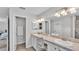 Bright main bathroom with double sinks, white cabinetry, and a neutral colored countertop at 204 Walkers Point Dr, Auburndale, FL 33823