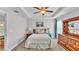 Main bedroom with a tray ceiling, ceiling fan and wooden dresser at 204 Walkers Point Dr, Auburndale, FL 33823