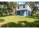 Expansive backyard with a modern home featuring a covered patio and green lawn at 2052 W Elliott St, Lakeland, FL 33805