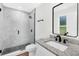 Modern bathroom with a sleek glass shower and vanity featuring granite countertops and black fixtures at 2052 W Elliott St, Lakeland, FL 33805