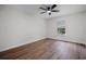 Bedroom featuring hardwood floors, a ceiling fan, and a large window at 2052 W Elliott St, Lakeland, FL 33805