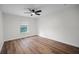 Bright bedroom features wood floors, a ceiling fan, and natural light from a window at 2052 W Elliott St, Lakeland, FL 33805