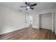 Bedroom with hardwood floors, a ceiling fan, closet, and an en-suite bathroom at 2052 W Elliott St, Lakeland, FL 33805
