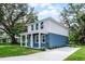 Two-story home with blue lower and white upper exterior, a concrete driveway, and landscaping at 2052 W Elliott St, Lakeland, FL 33805