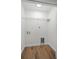 Practical laundry room with a convenient wire shelf and pet door, perfect for organization at 2052 W Elliott St, Lakeland, FL 33805