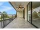 Balcony features black metal railings, light tile and a ceiling fan at 208 Lake Howard Nw Dr # 104, Winter Haven, FL 33880