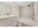 Clean bathroom features a bathtub and shower, commode, and a single sink vanity with drawers at 208 Lake Howard Nw Dr # 104, Winter Haven, FL 33880