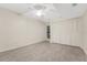 Bedroom with tile floors, double door closet, ceiling fan, and one window at 208 Lake Howard Nw Dr # 104, Winter Haven, FL 33880