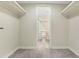 Walk-in closet leads to the Primary bathroom with updated tile floors and commode at 208 Lake Howard Nw Dr # 104, Winter Haven, FL 33880