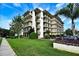 Multi-story condo building with green lawn and meticulous landscaping offers a welcoming curb appeal at 208 Lake Howard Nw Dr # 104, Winter Haven, FL 33880