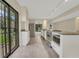 Modern kitchen features granite countertops, stainless appliances, and sliding door for lots of light at 208 Lake Howard Nw Dr # 104, Winter Haven, FL 33880