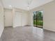 Bright living area with tile floors, double closets and lots of natural light from sliding door at 208 Lake Howard Nw Dr # 104, Winter Haven, FL 33880