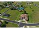 An aerial image of a single Gathering home near tennis and basketball courts, showcasing the community amenities at 209 Pine Lilly Ct, Lake Alfred, FL 33850