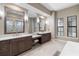 Bathroom featuring double vanity sinks, makeup vanity and stool, and a garden tub with lots of natural light at 209 Pine Lilly Ct, Lake Alfred, FL 33850