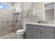 A new bathroom has neutral gray tiling in the walk-in shower with a glass door and granite countertops at 209 Pine Lilly Ct, Lake Alfred, FL 33850