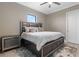 Modern bedroom features a dark wood frame bed, plush pillows, hardwood floors, and a window for natural light at 209 Pine Lilly Ct, Lake Alfred, FL 33850