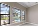 View of the pool and screened-in patio from the large, energy efficient windows in the bedroom at 209 Pine Lilly Ct, Lake Alfred, FL 33850