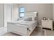 Bright bedroom with a mirrored bed, hardwood floors, and a large window at 209 Pine Lilly Ct, Lake Alfred, FL 33850