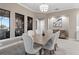 Dining room features a large table with seating for six and modern chandelier lighting at 209 Pine Lilly Ct, Lake Alfred, FL 33850