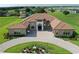 A beautiful front exterior showcases a circular driveway, landscaped garden and a stately home with great curb appeal at 209 Pine Lilly Ct, Lake Alfred, FL 33850