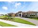 Charming front exterior with manicured lawn, paver driveway, and beautiful facade at 209 Pine Lilly Ct, Lake Alfred, FL 33850