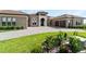 Lovely front exterior view featuring a well-manicured lawn and a paved driveway at 209 Pine Lilly Ct, Lake Alfred, FL 33850