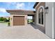 A view of the house's garage, showcasing the brick-paved driveway at 209 Pine Lilly Ct, Lake Alfred, FL 33850