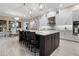 Open kitchen with a large island, stainless steel appliances, pendant lighting, and plenty of counter space at 209 Pine Lilly Ct, Lake Alfred, FL 33850