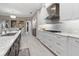 Elegant kitchen with stainless steel appliances, granite countertops, and custom white cabinetry at 209 Pine Lilly Ct, Lake Alfred, FL 33850